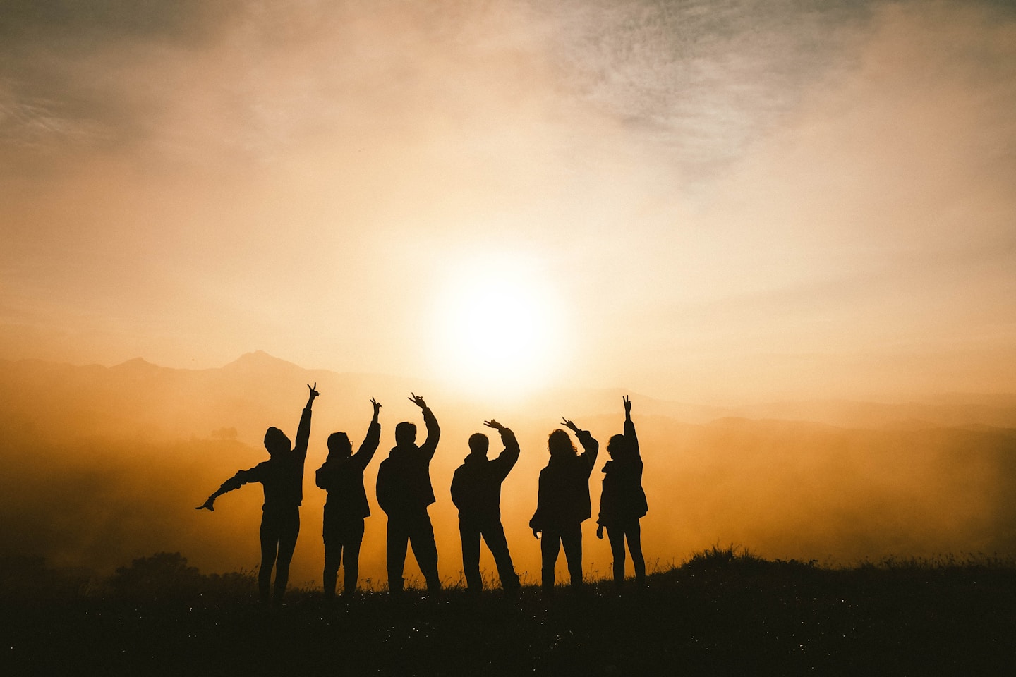 Friends on a group trip in Kenya, laughing together at sunset while traveling